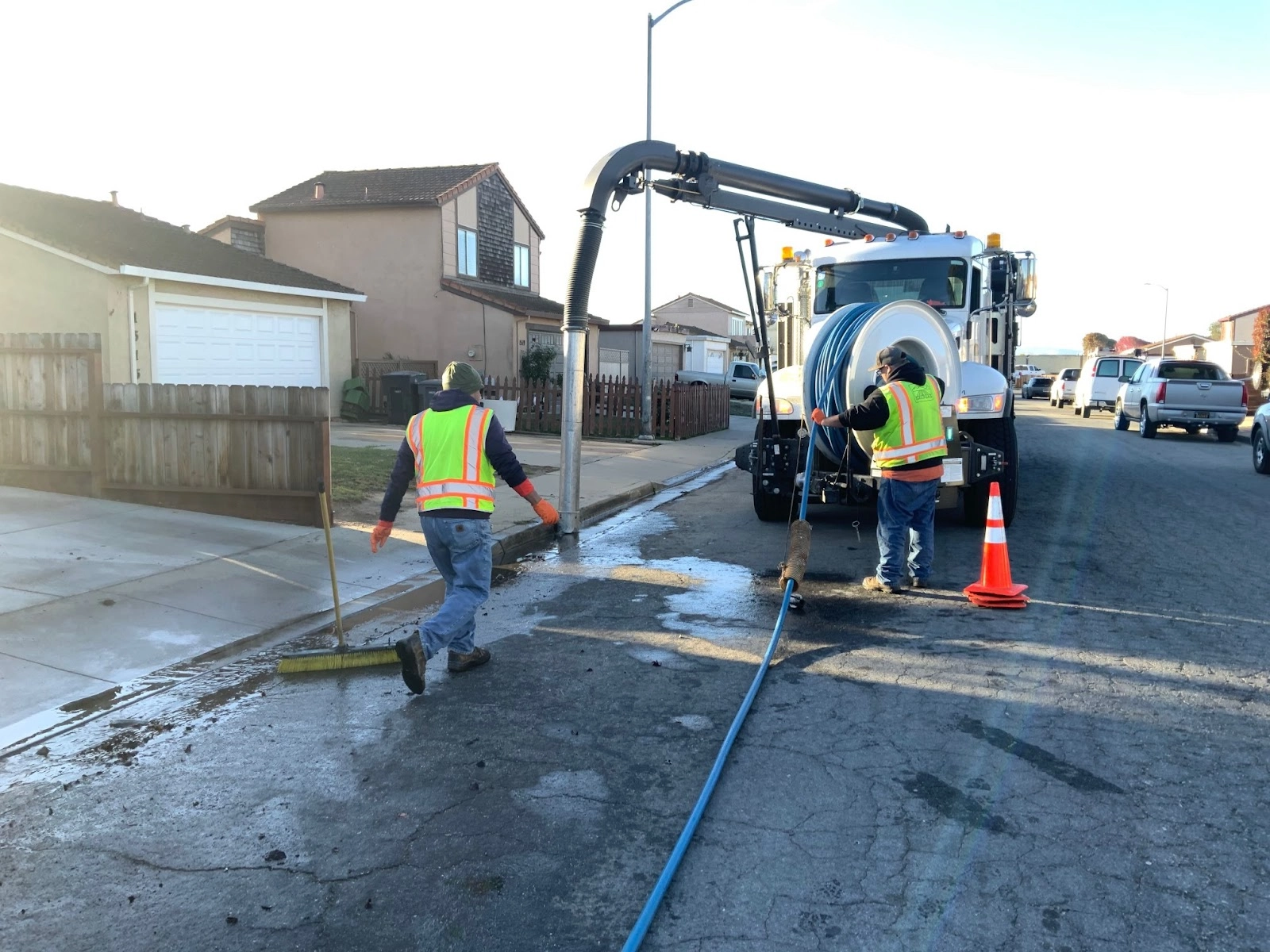 Vactor truck and crew performing storm sewer cleaning and maintenance on City of Salinas street